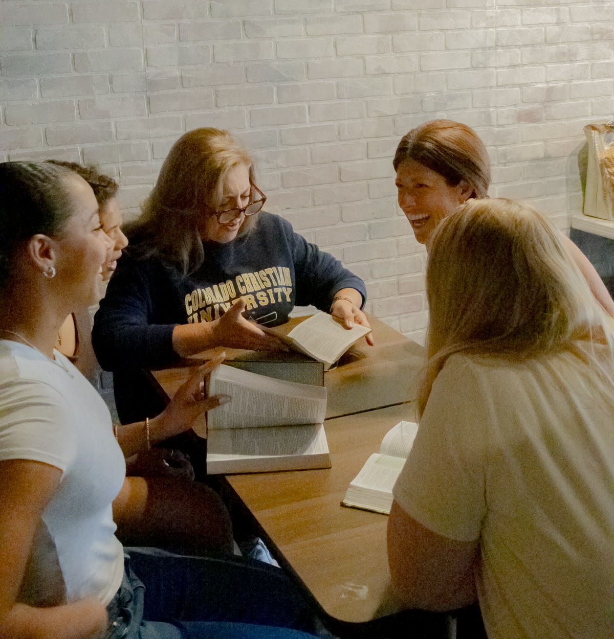 Michelle Mingo guiding a discipleship conversation around an open Bible
