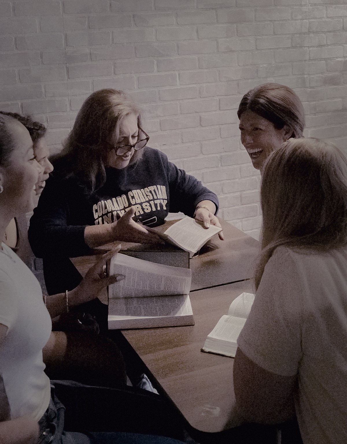 Michelle Mingo guiding a discipleship conversation around an open Bible